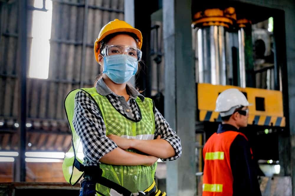 Two women wearing protective masks in a Manufacturing Center.