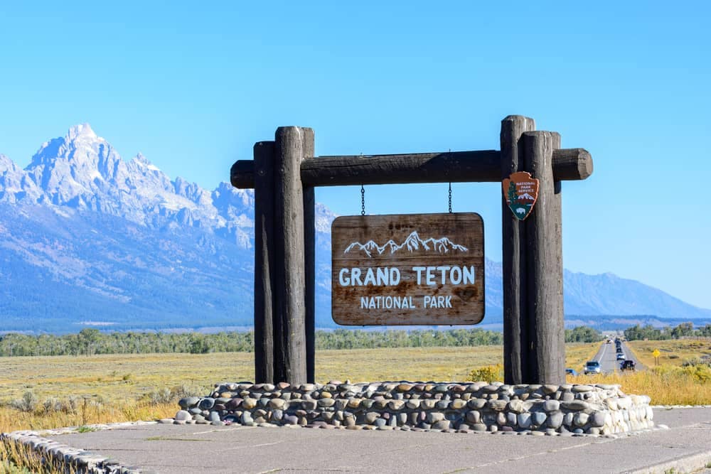 Grand Teton National Park sign with park buildings.