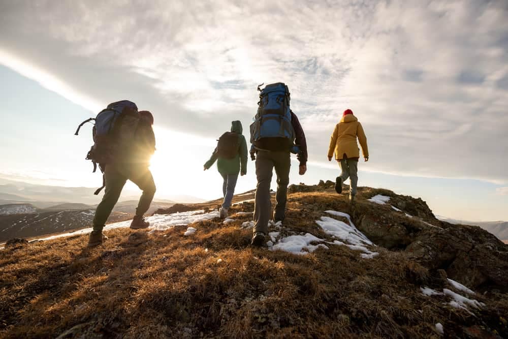 Group of hikers enjoying scenic views on top of a mountain in Victoria.