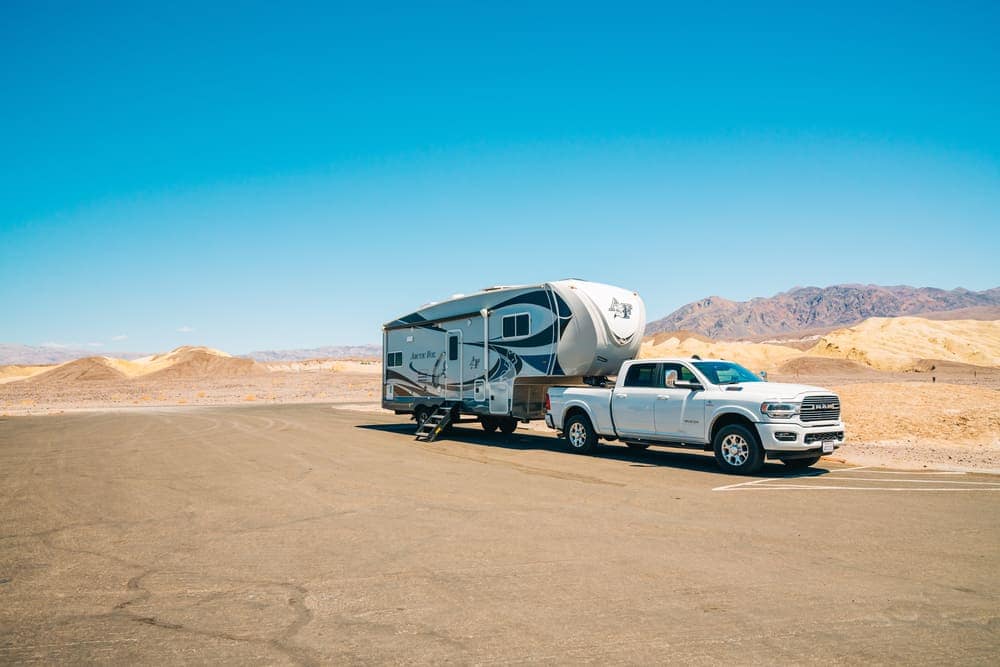An All-Electric Camper Trailer towing an rv in the desert of Condamine, Australia.
