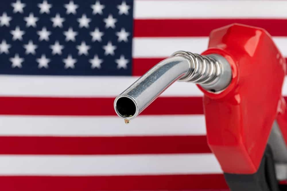 An American flag proudly displayed in front of a gas pump.
