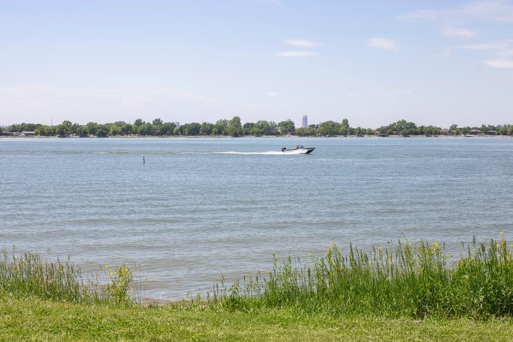A newly improved campground near Lake Manawa State Park with a boat on the water near a grassy area.