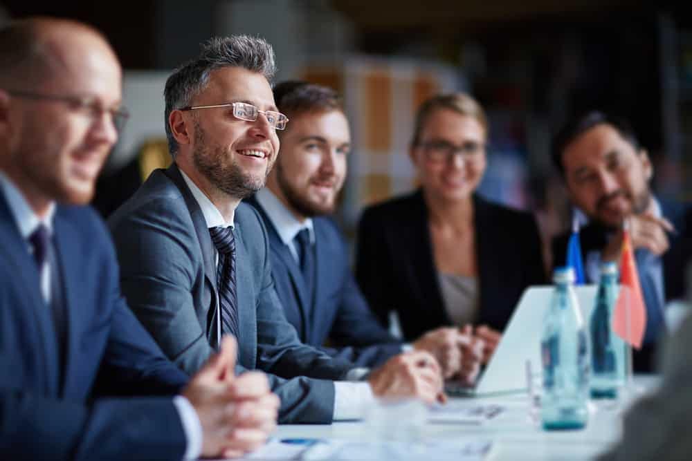 A group of business people from the RV industry sitting at a conference table.