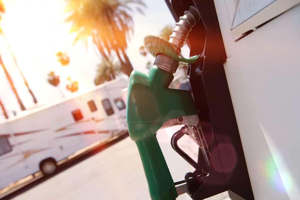A green RV fills up with gas at a gas station along Rincon Parkway.