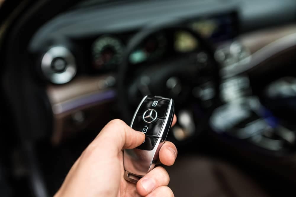 A person holding a Mercedes-Benz remote control in a car at the Caravan Salon Düsseldorf.