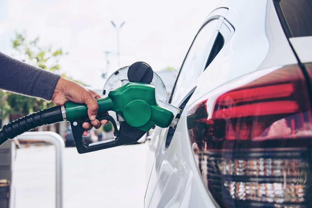 A person enjoying an RV vacation fills up their car with fuel for free at RV Fun Rental.
