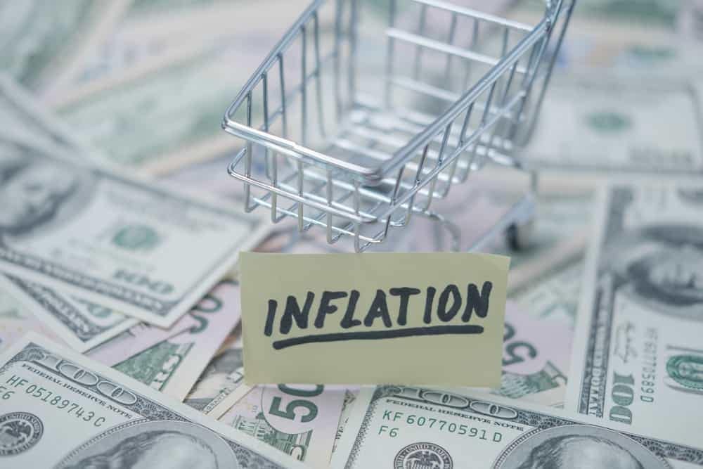 A shopping cart with the word inflation prominently displayed on top.