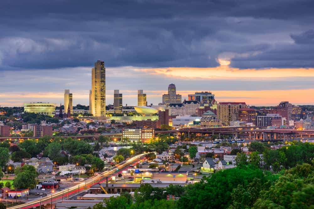 A city skyline at dusk with a cloudy sky, showcasing the vibrant CONY atmosphere and inviting outdoor hospitality.