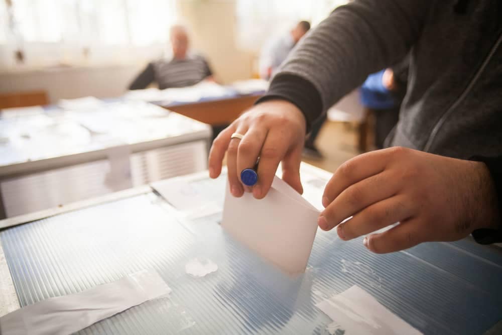 A person is putting a vote into a voting box during an election for the board of directors of RVIA.