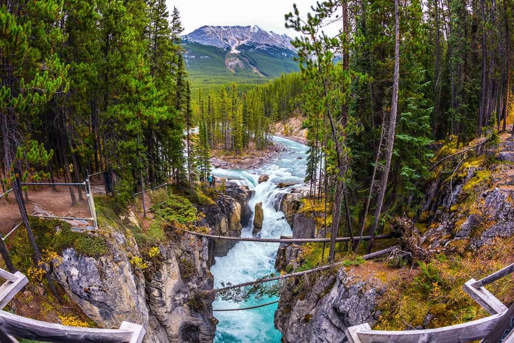 A bridge over a river in Banff National Park, Canada, providing easy access for campers and Scouts Canada members to explore the beautiful canyon.