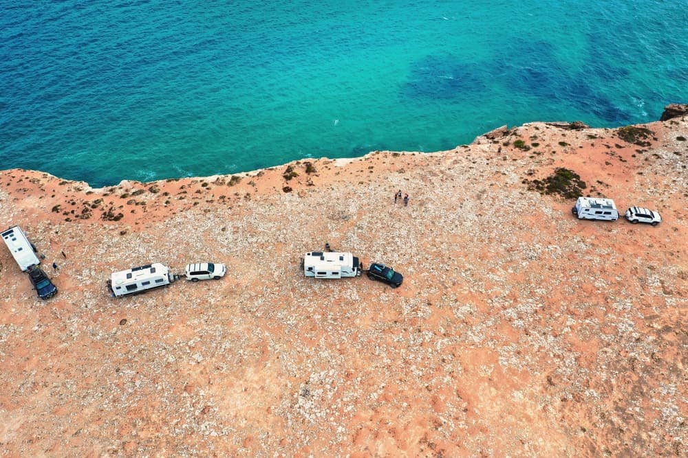 Aerial view of a group of RVs parked near the ocean at the Sunshine Coast Caravan Show.