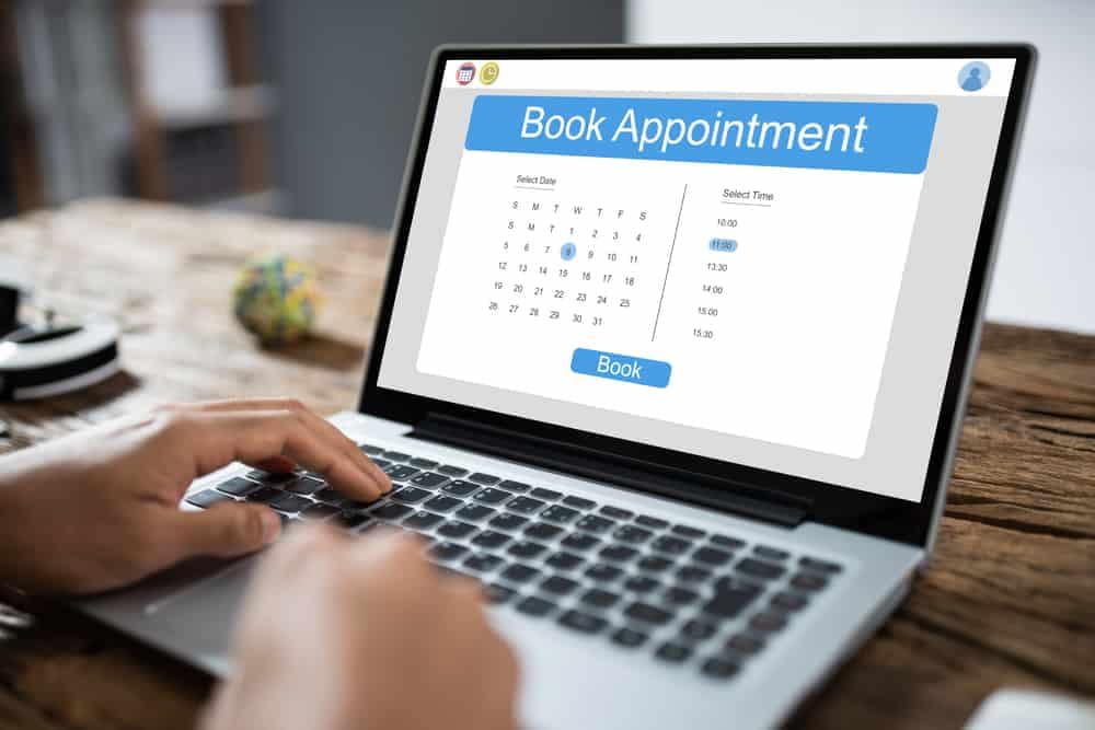 A person in Western Australia improves their camping experience by using an online campsite booking system on their laptop to make a book appointment.