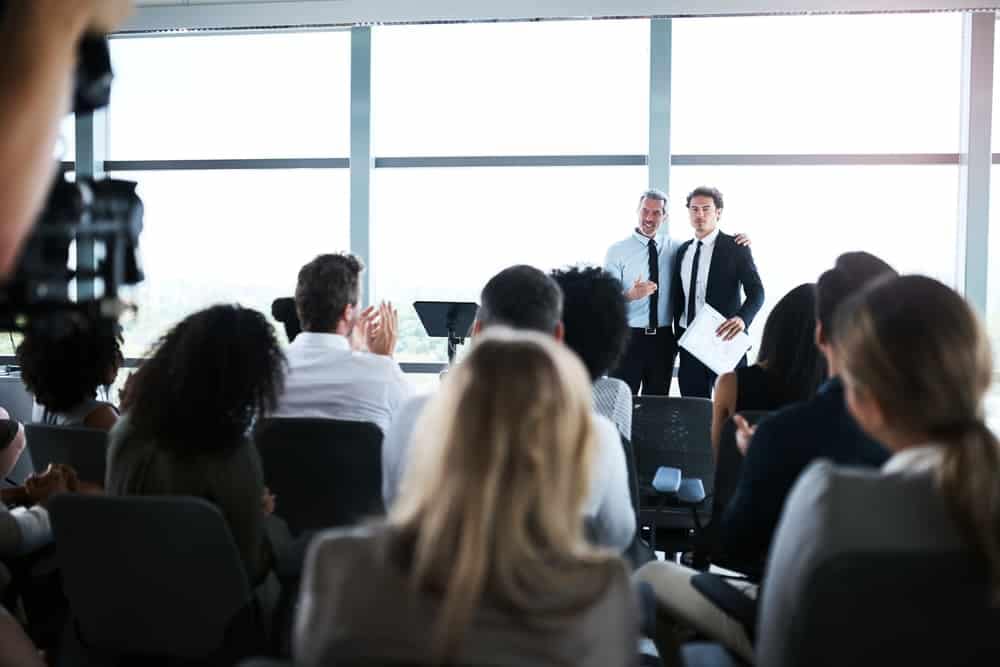 The largest RV Retailer's executive presenting in a conference room.