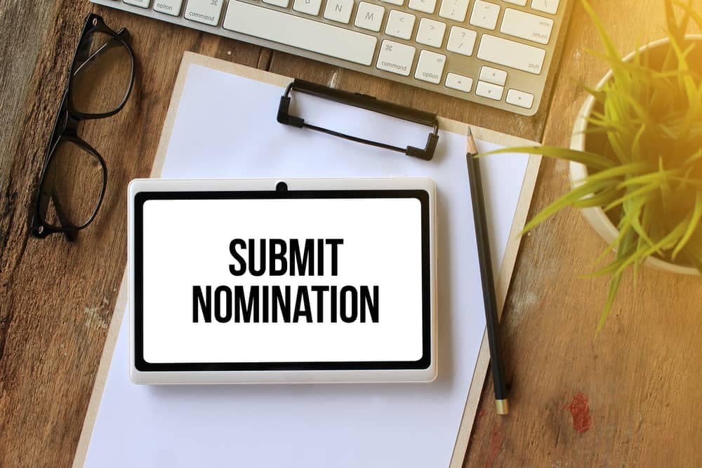 A tablet displaying the words "submit nomination" for the RV Women's Alliance Awards.