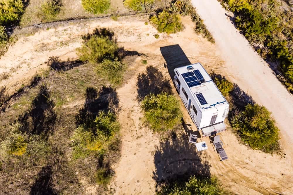 An aerial view of a BougeRV rv parked on a dirt road in the Canadian market.