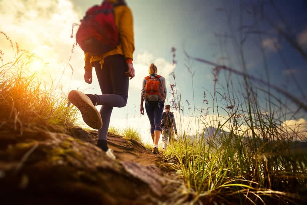 A group of people hiking on a trail in the mountains for National Public Lands Day.