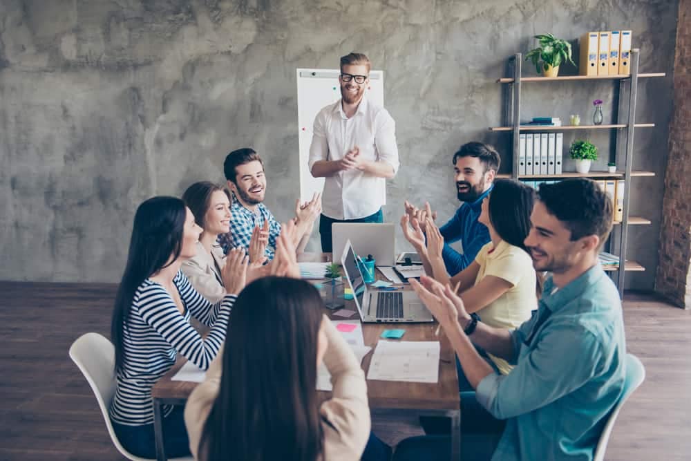 The State Government Affairs Team from RVIA builds relationships at a meeting, with a group of people clapping in appreciation.