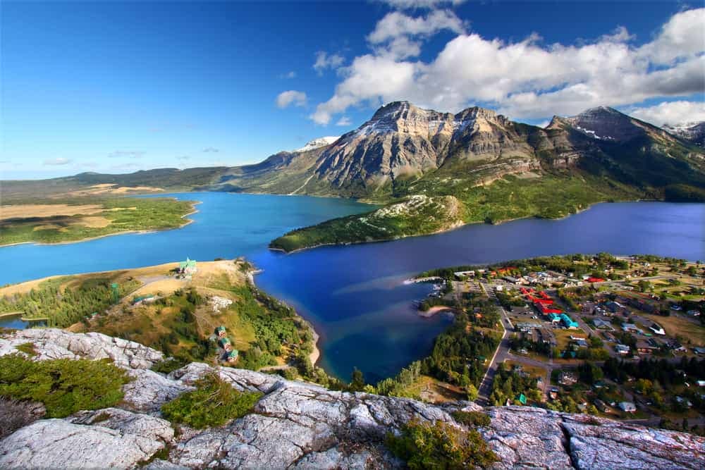 An aerial view of Waterton Lakes National Park, showcasing its pristine lake and majestic mountains.
