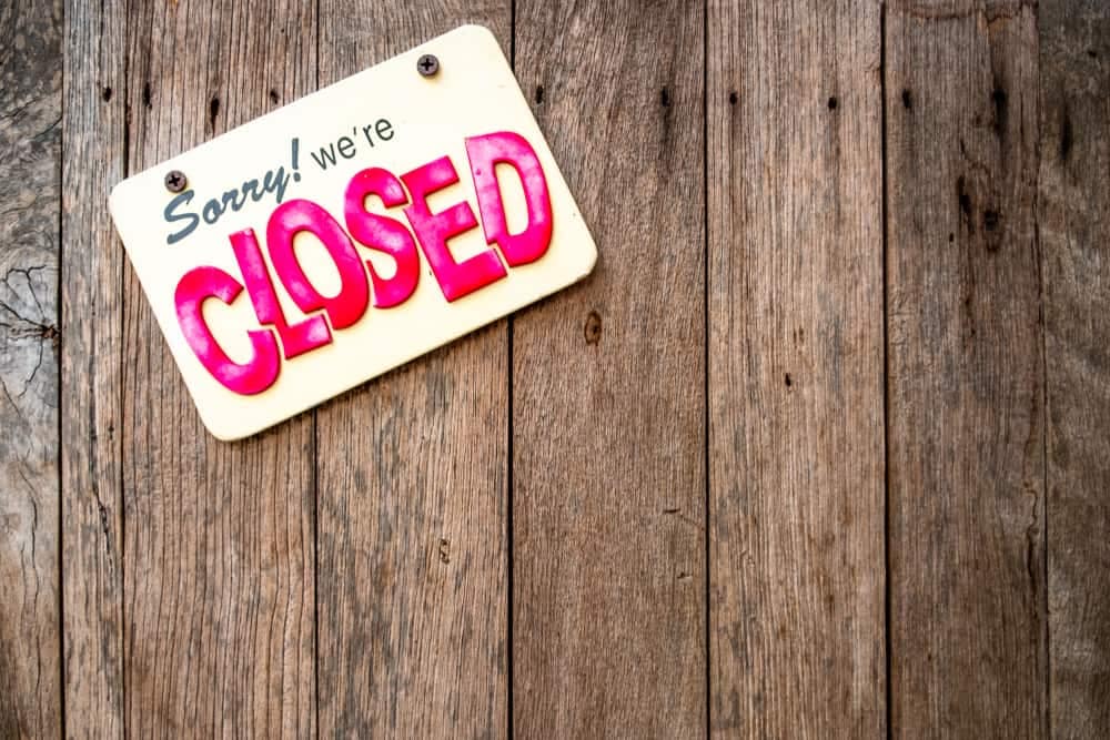 A closed sign hanging on a wooden wall at North Wood County Park Campgrounds.
