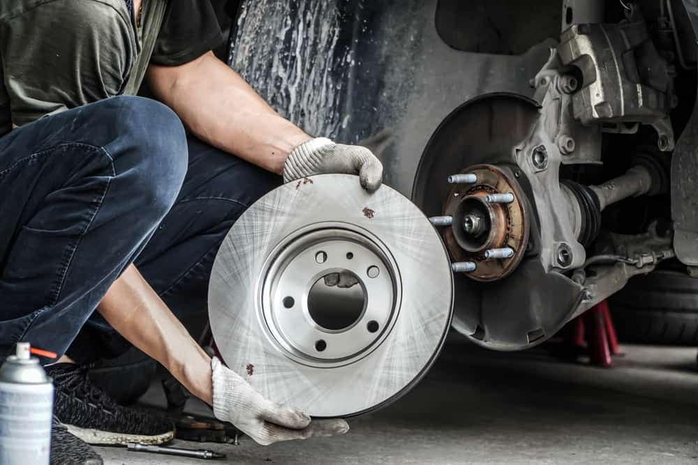 A man, equipped with Cub Elecparts tools, expertly fixing a brake disc on an RV for the US Market.