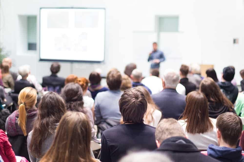 A group of people at an Expo Workshop watching a presentation.