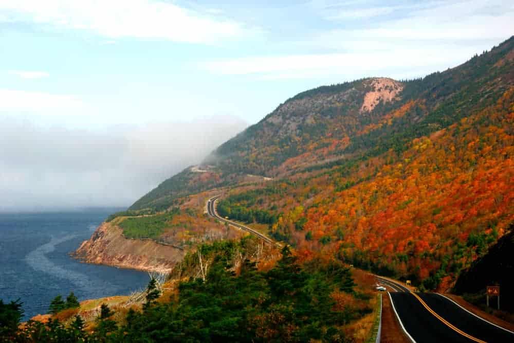 A road in Cape Breton Highlands National Park leading to a cliff overlooking the ocean.