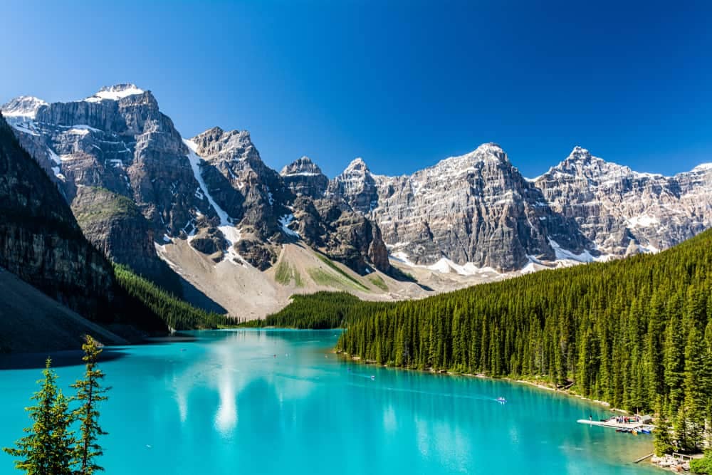 A blue lake surrounded by mountains in Banff National Park, Canada with upgrades.