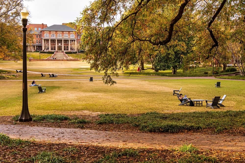 A North Carolina State Park with benches and trees in the background, providing amenities to visitors through funds.