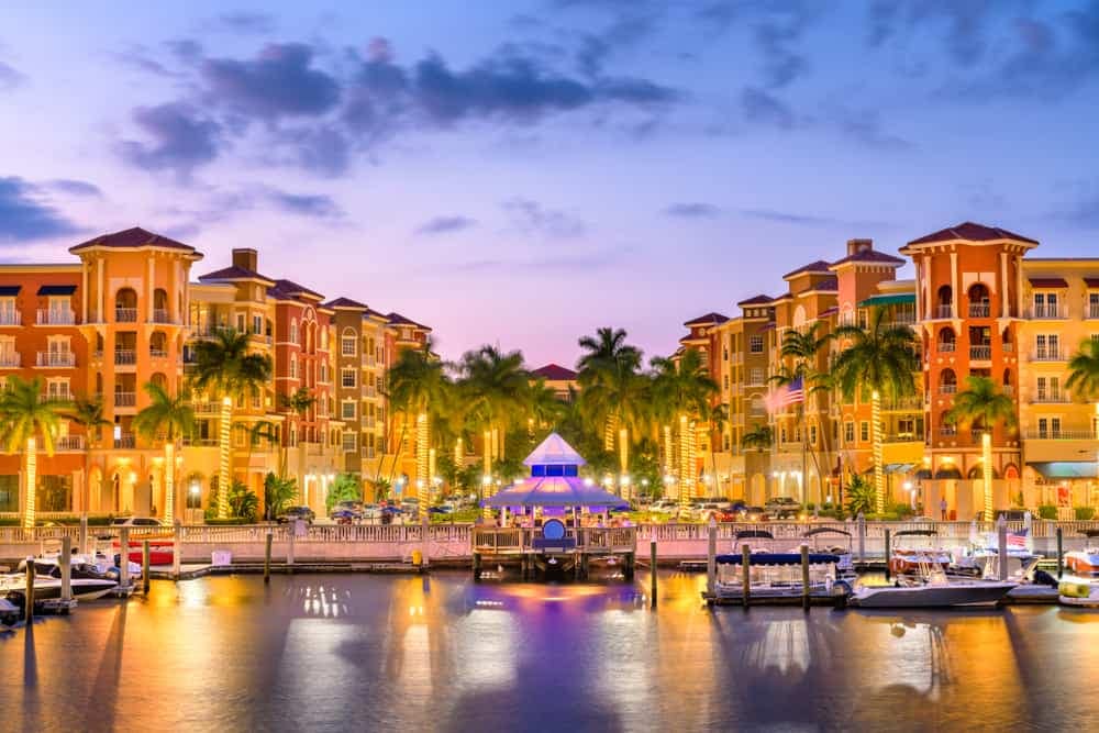 A record-breaking marina at dusk in Florida with boats docked in the water, contributing to the thriving tourism industry.