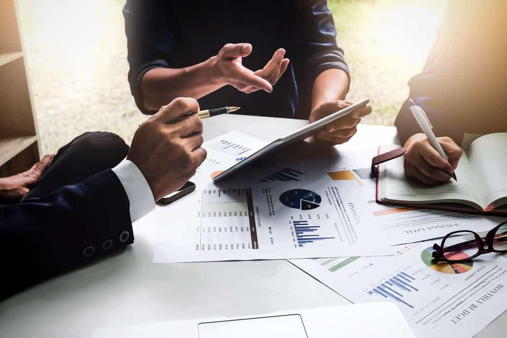 A group of business people, representing a Lifestyle Company, sitting around a table.