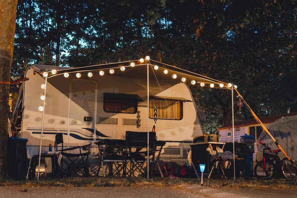 A Kmart camper is lit up at night with string lights from their new collection.