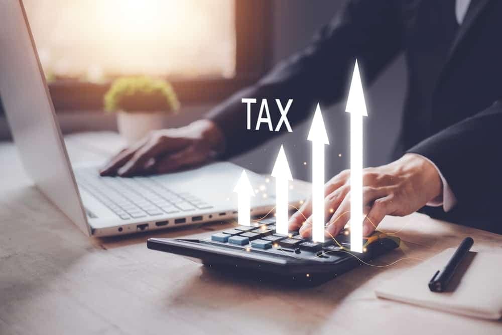 A businessman in Minnesota is using a calculator to calculate taxes for local sales tax initiatives related to campgrounds.