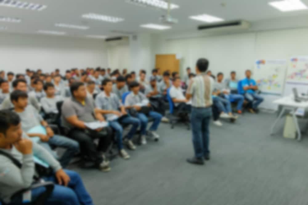 A man is giving a presentation on RVTI training to a group of people.