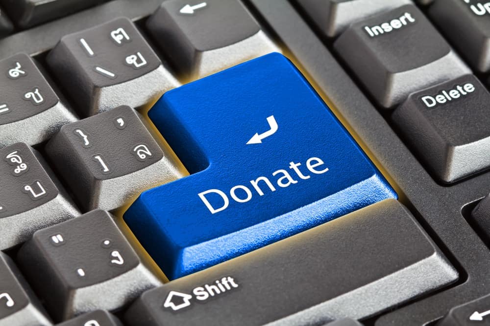 A blue button with the word donate on it, supporting disaster-impacted campgrounds through the ARVC Foundation.