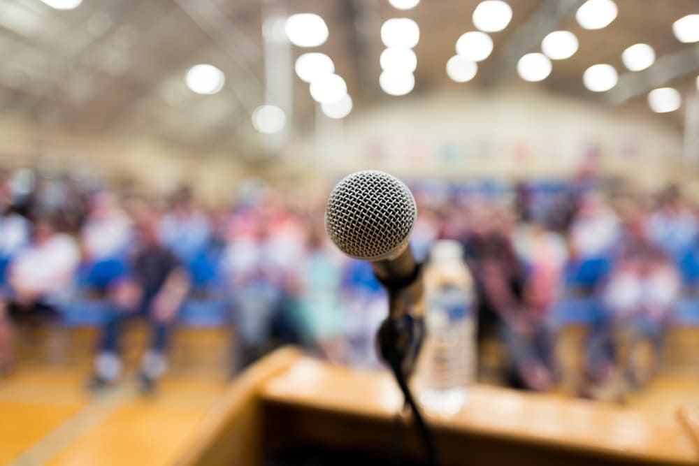 A microphone in front of a crowd at the Former Boyd's Bears Site during the Cumberland Township Campground Development.