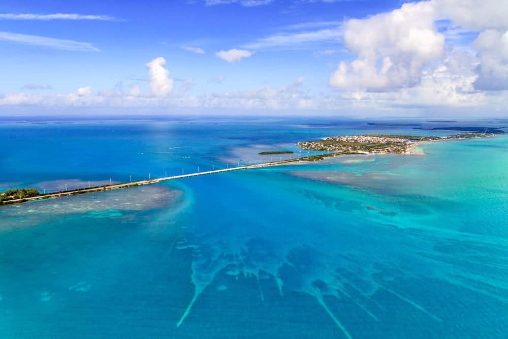 An aerial view of a blue ocean and a bridge debuts in Islamorada, offering a scenic Florida Keys experience.