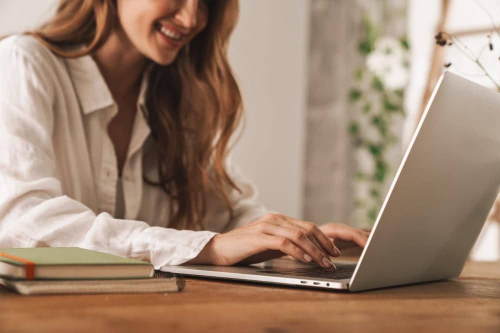 A woman using the Interactive Tool on her laptop to calculate revenue.