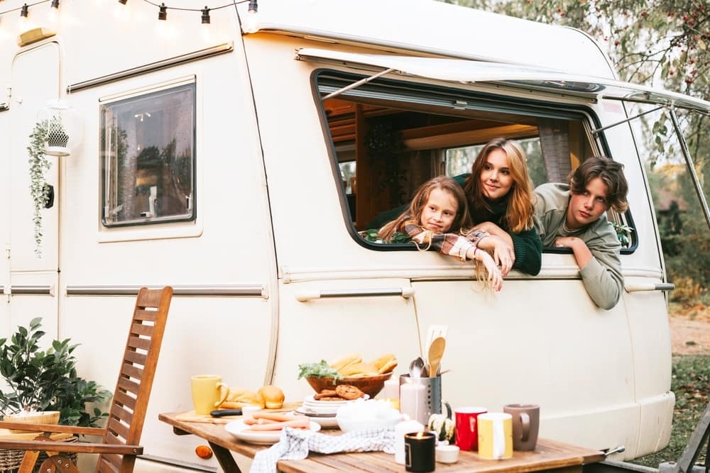 A cost-effective family enjoys their RV vacation with food on the table.