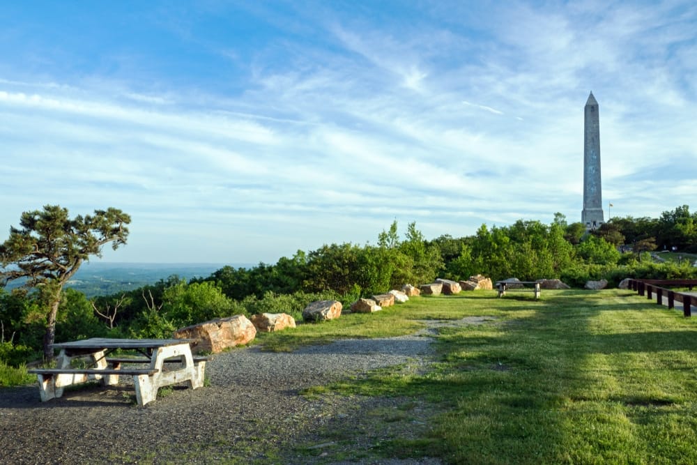 The Washington Monument offers stunning views, perched atop a hill and surrounded by a vast grassy area.