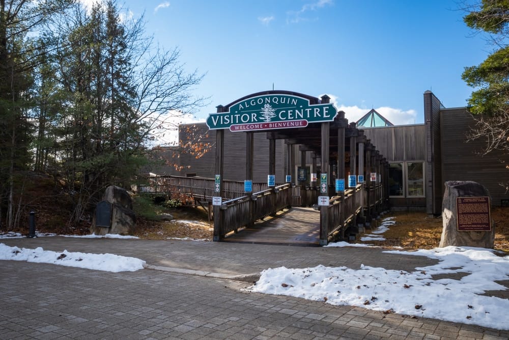 The entrance to a museum with snow on the ground in Algonquin Provincial Park.