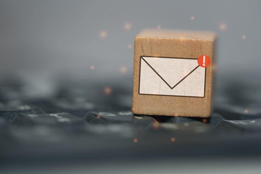 A wooden block with an email icon on top of a keyboard, representing communication and digital connectivity related to campground availability and PRO Membership.