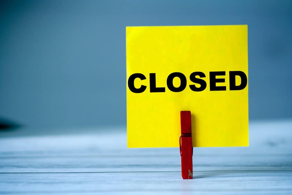 A yellow sign with the word closed on it at a KOA Campground in Michigan due to safety concerns.