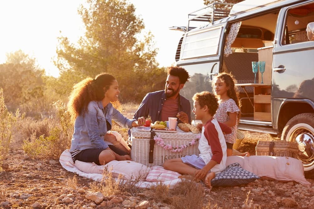 Family enjoying a picnic in a VW camper van at Sherman Reservoir State Recreation Area.