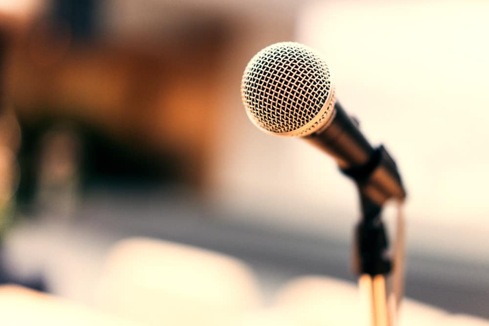 A close up of a microphone in front of a table as the Veteran Service Department Foreman discusses strategies to improve efficiency.