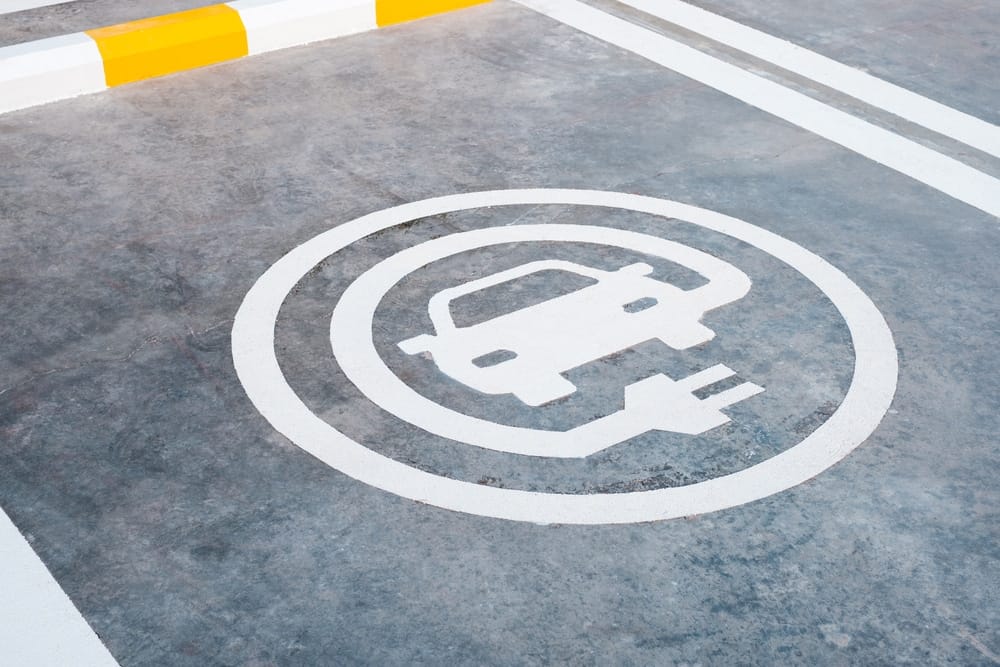 A car is parked in a parking lot equipped with Swift Charge technology.
