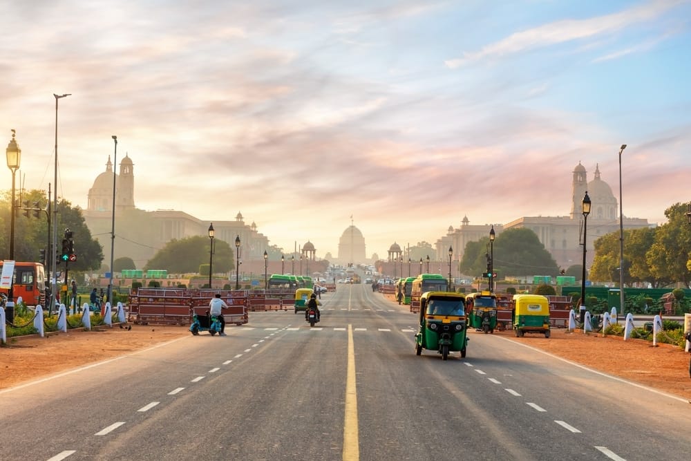 A street in New Delhi, India at sunset, perfect for outdoor hospitality and tourism activities.
