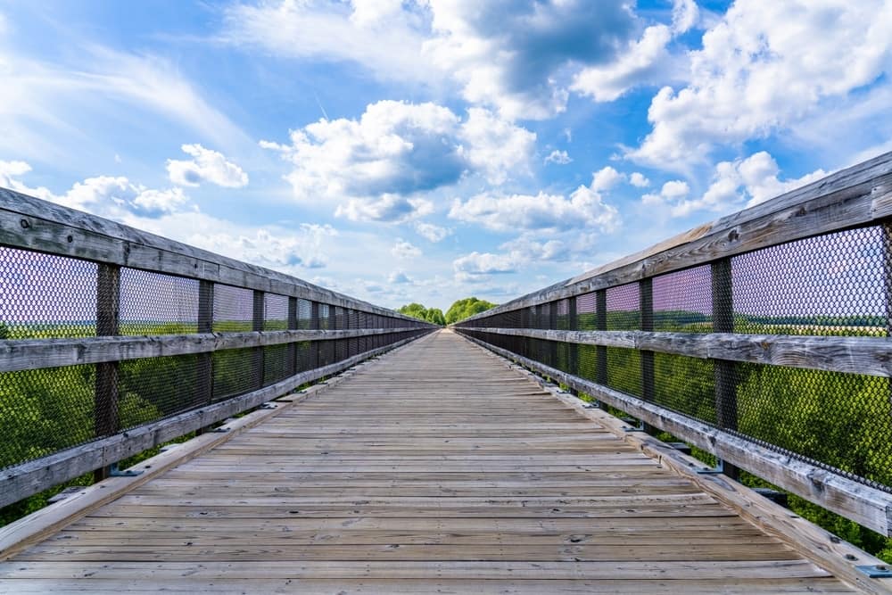 A wooden bridge leading into High Bridge Trail State Park.