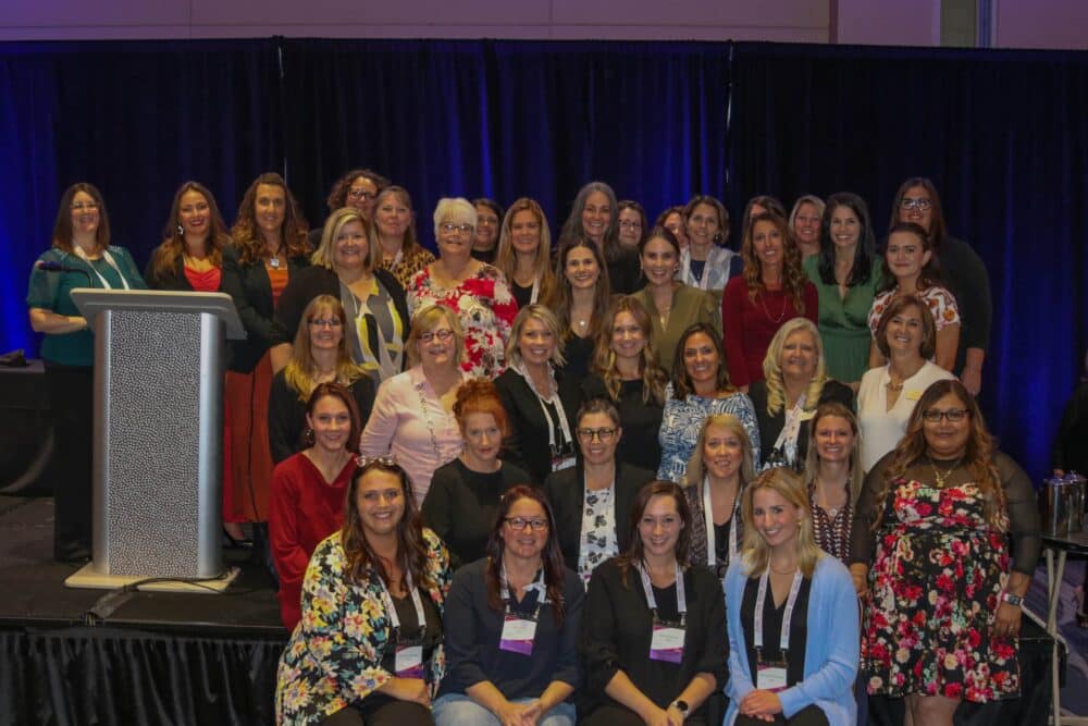A group of women posing for a photo at the RVWA Educational Symposium.