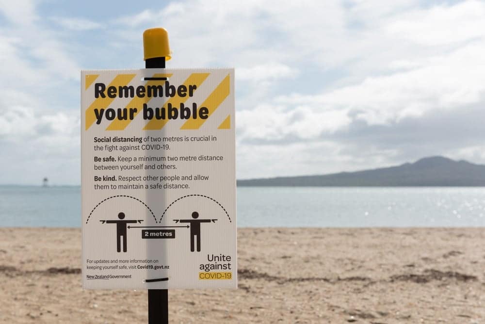 In New Zealand, amidst lockdowns, a beach sign reminds trampers to remember their bubble.