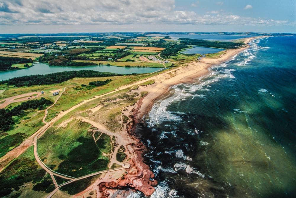 An aerial view of Prince Edward Island National Park's expansion, showcasing its breathtaking beach and ocean.